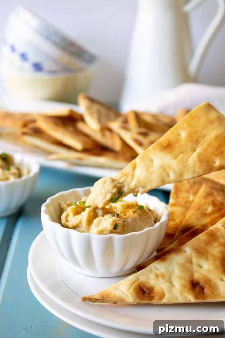 Irresistible Game Day Appetizer Recipes 9 Quick pita chips with a dip of garlic hummus.