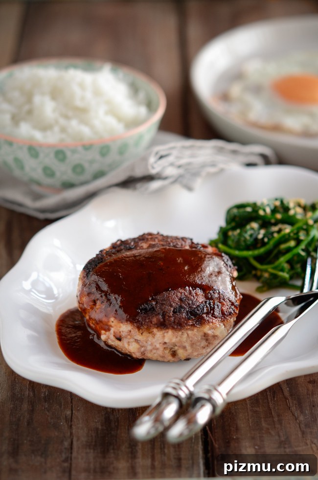 Classic Japanese Hambagu (Hamburger Steak) Recipe 2 Japanese hamburger steak is drizzled with red wine sauce and served with rice and spinach.