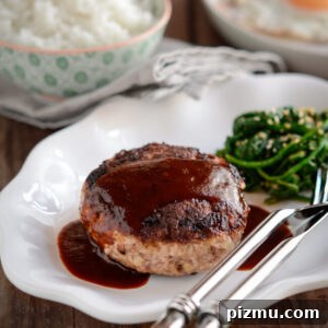 Classic Japanese Hambagu (Hamburger Steak) Recipe 13 Hambagu is drizzled with red wine sauce and served with rice and spinach.