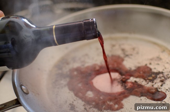 Classic Japanese Hambagu (Hamburger Steak) Recipe 7 Red wine is poured on a hot skillet to deglaze the meat dripping.