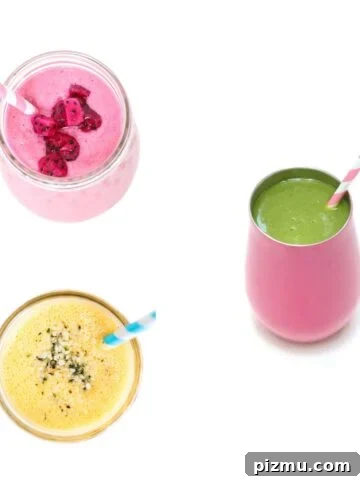 Three fruit smoothies with straws.