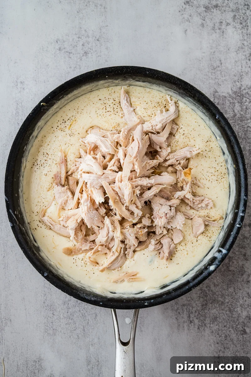 Creamy Chicken Alfredo Lasagna with Ricotta Recipe 11 Chicken is added to the skillete.
