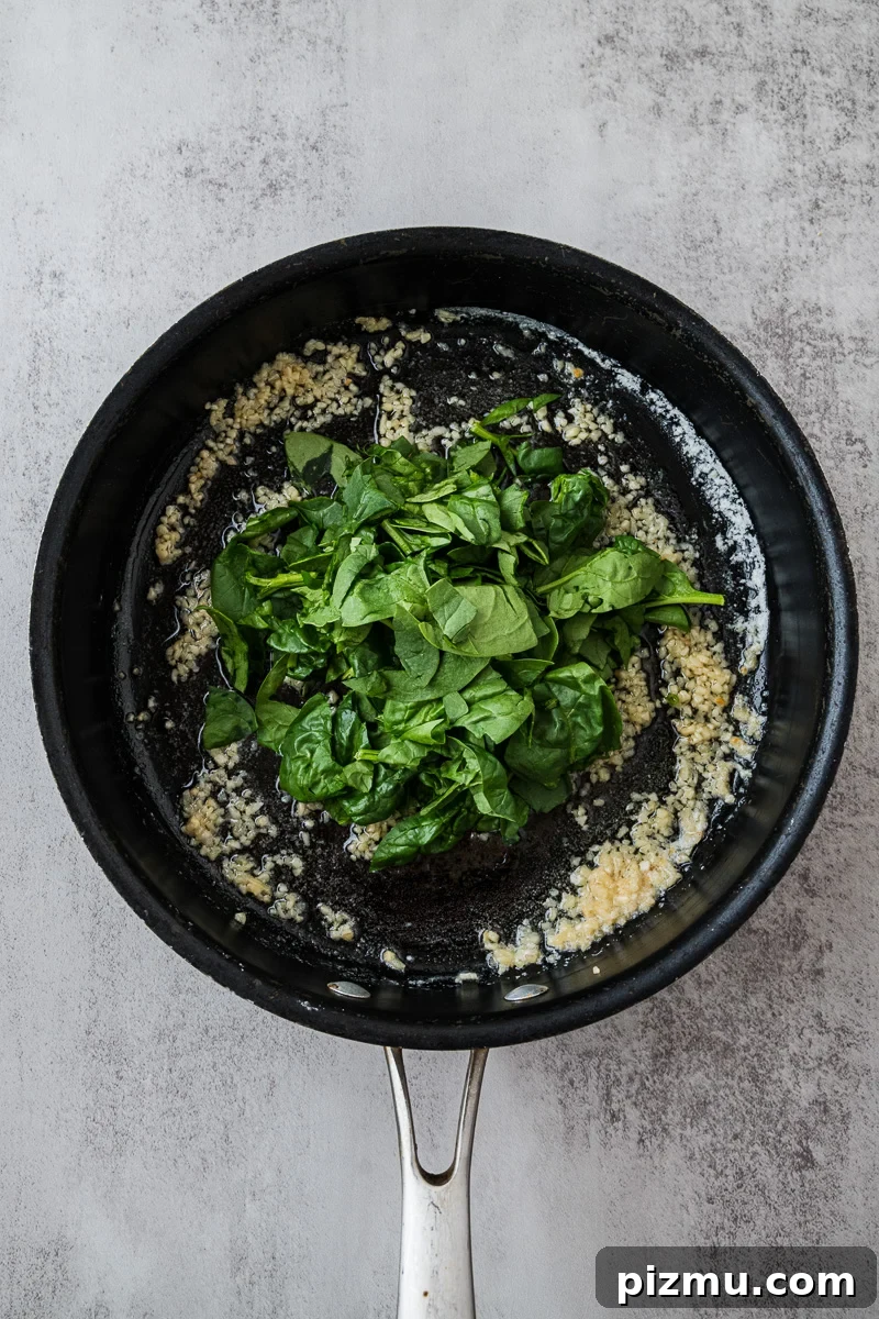 Creamy Chicken Alfredo Lasagna with Ricotta Recipe 6 Spinach is added to skillet with the butter and garlic.