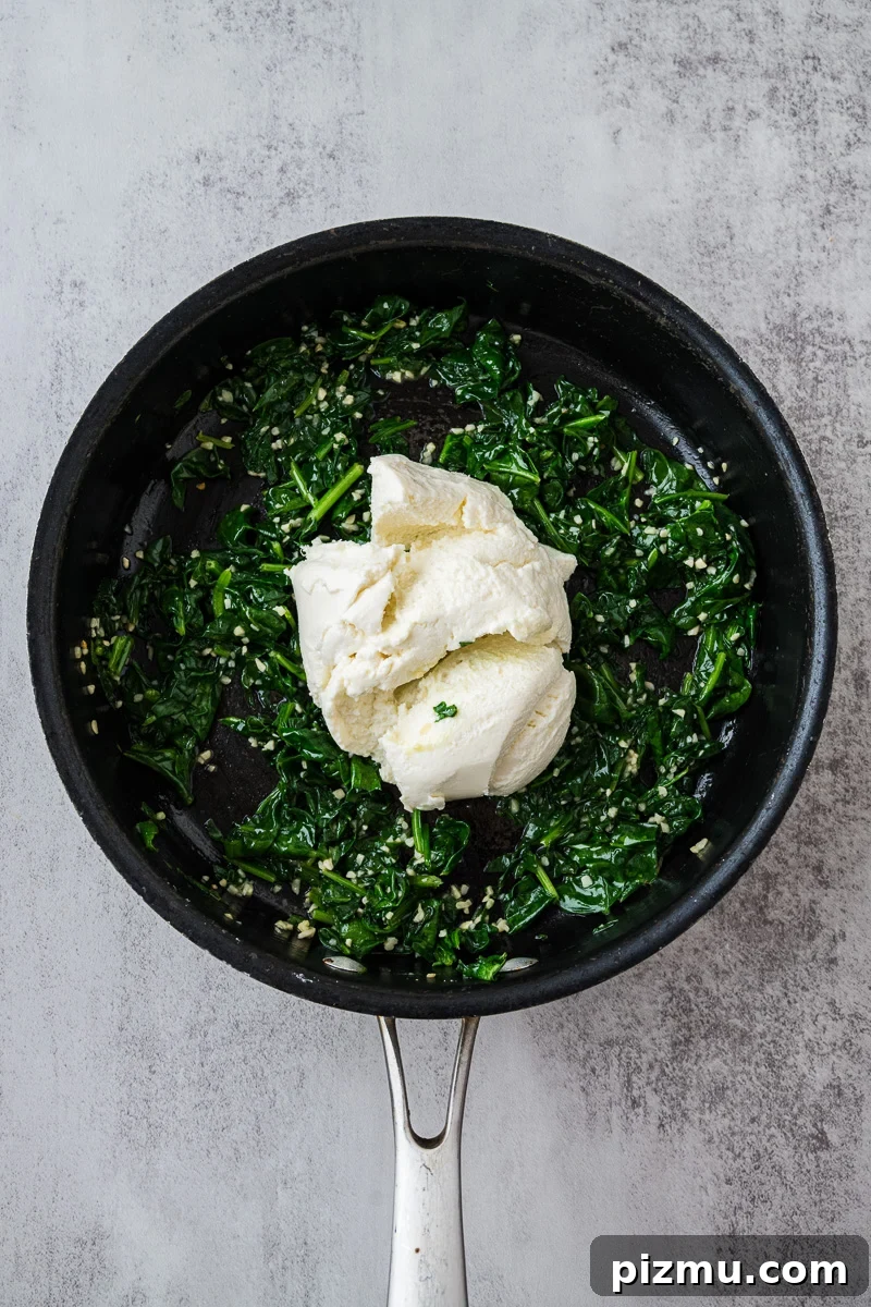 Creamy Chicken Alfredo Lasagna with Ricotta Recipe 7 Ricotta is added to the spinach mixture in skillet.