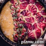 Daniela Gerson's hands the olive olive and fresh strawberry cake, overhead shot.
