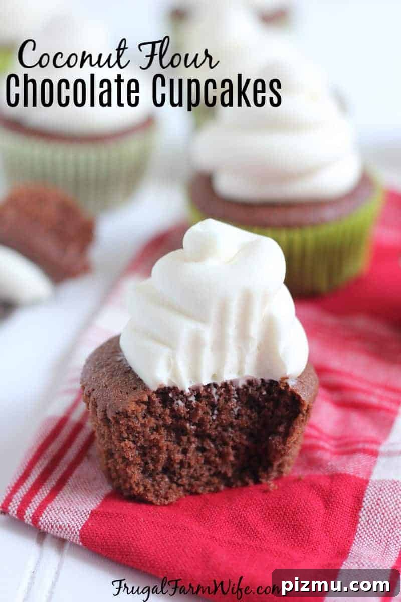 Gluten-Free Coconut Flour Chocolate Cupcakes 2 Image shows cupcakes on a red and white napkin. The chocolate cupcake at the forefront has a bite taken out of it with white frosting swirled on top.