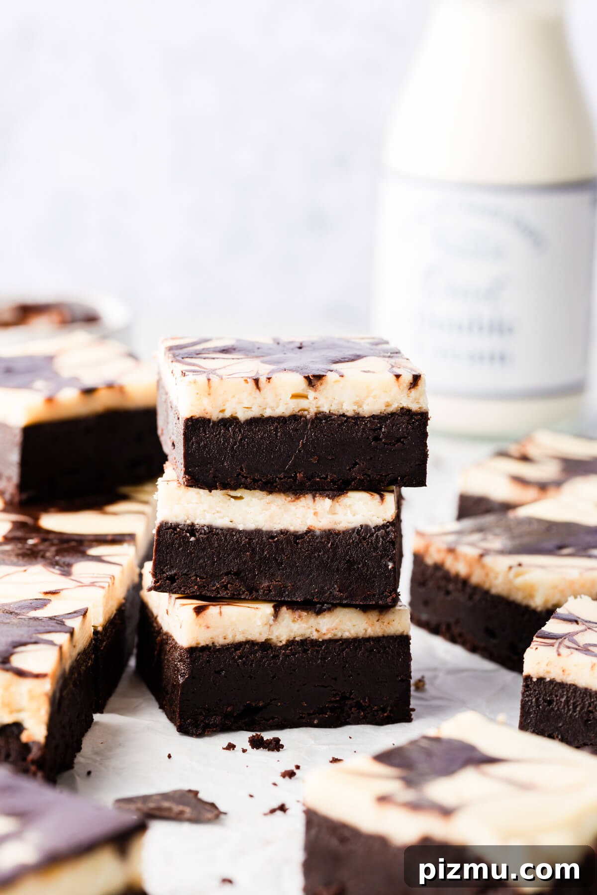 Cheesecake Swirl Brownies with Cream Cheese Filling 11 side super close up of 3 individual cream cheese brownies on top of each other
