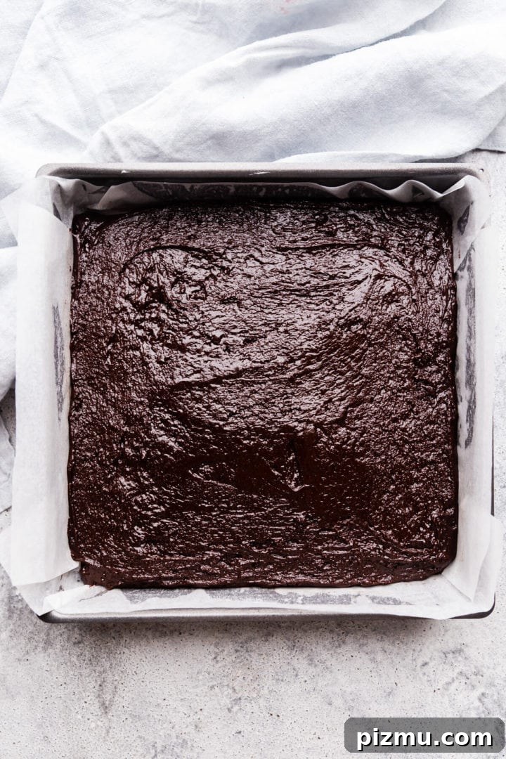 Cheesecake Swirl Brownies with Cream Cheese Filling 6 top view of the baking tin filled with brownie batter layer