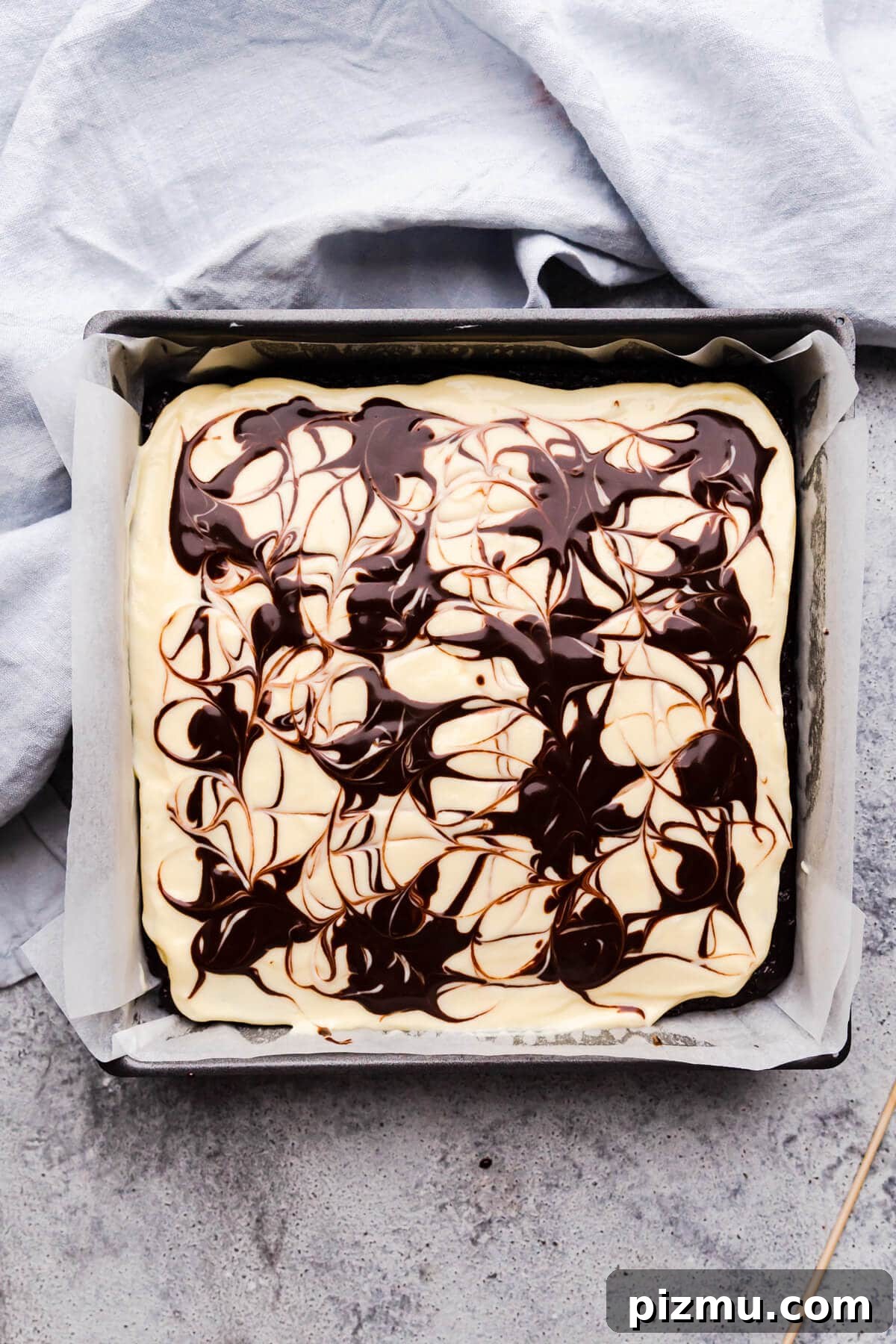 Cheesecake Swirl Brownies with Cream Cheese Filling 9 overhead view of square baking tin with cheesecake brownie batter inside