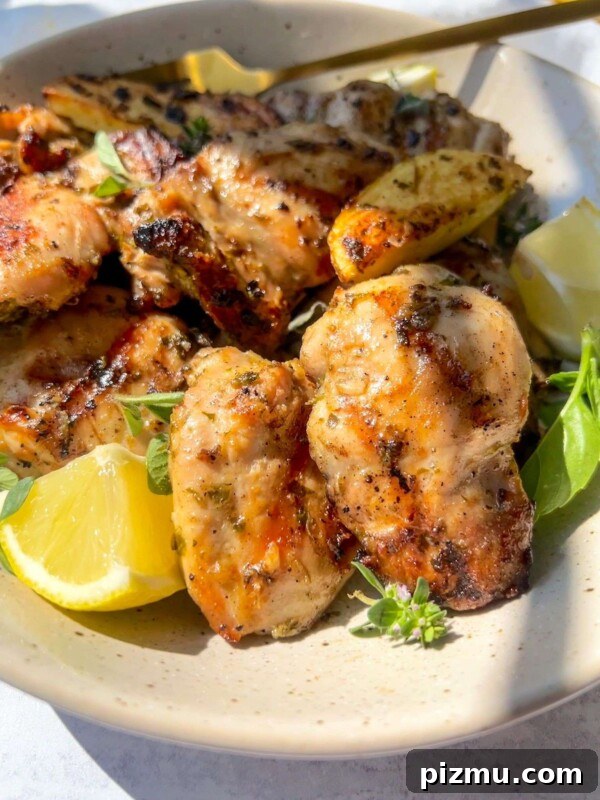 Juicy Grilled Lemon Chicken with Garlic and Herbs 6 Herb marinated chicken pieces with lemon wedges and fresh herbs.