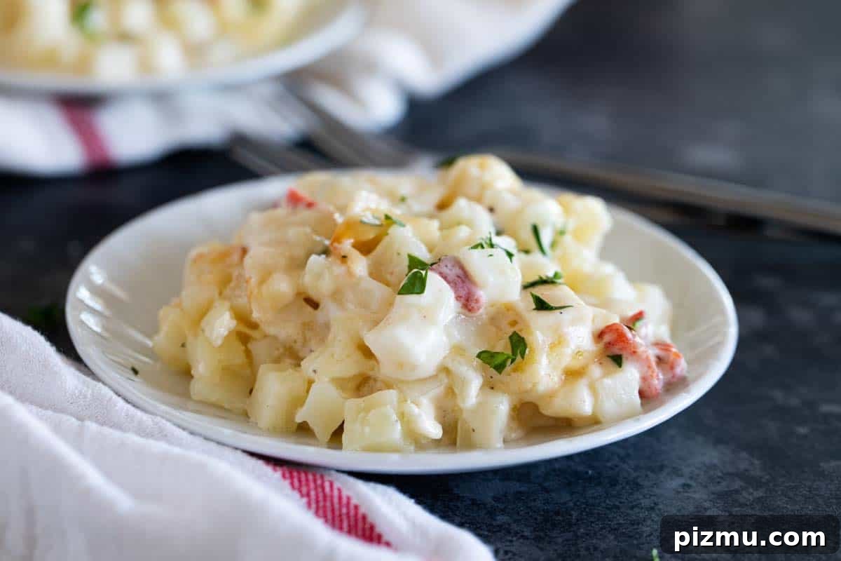 Creamy and easy, these Crockpot Cheesy Potatoes are a great side dish recipe, perfect for feeding a crowd! Plate with Crockpot Cheesy Potatoes topped with parsley.