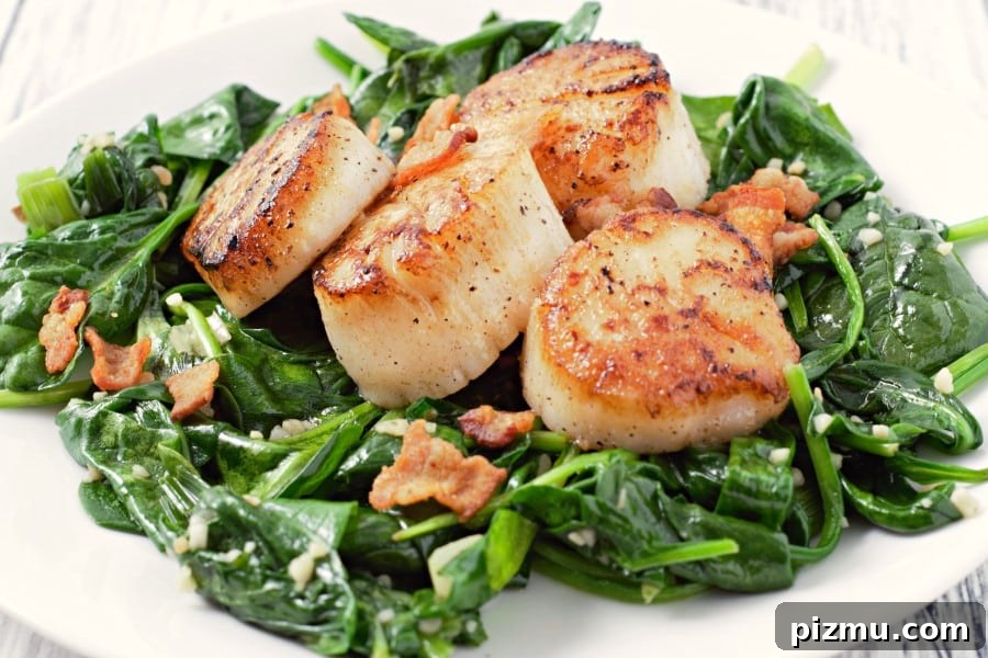 Seared Scallops with Garlic Butter Spinach 8 Pan Seared Scallops with Bacon and Spinach on a plate