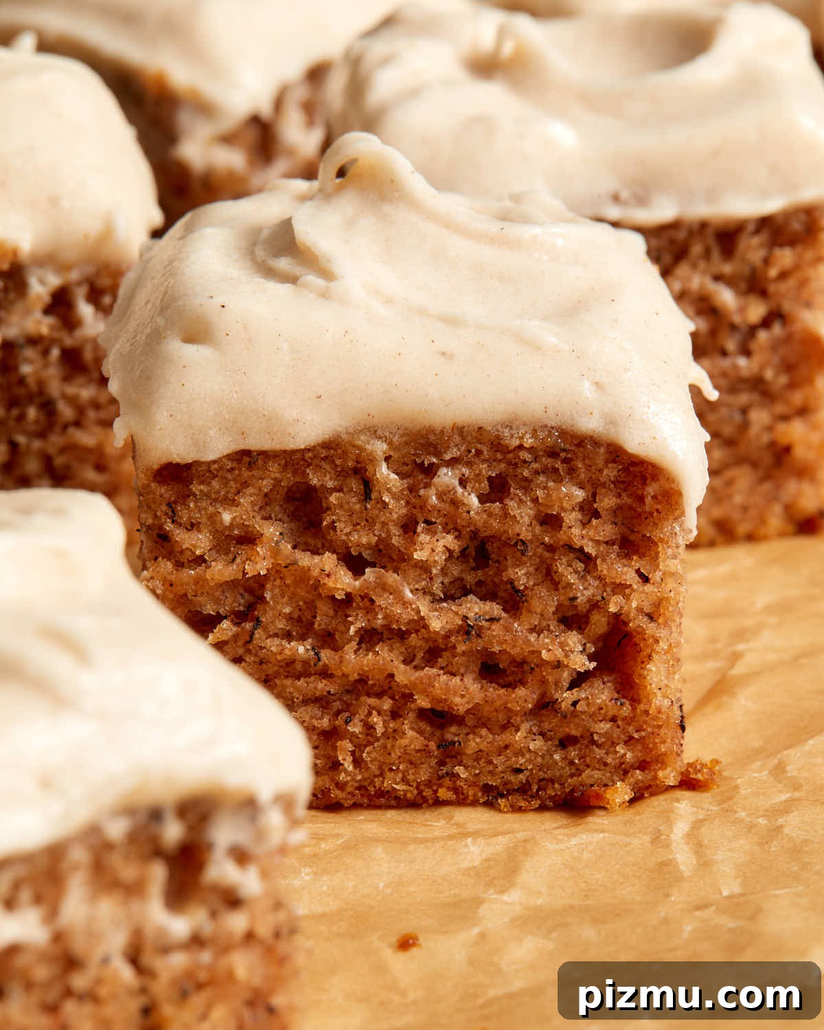 Moist Banana Cake Recipe with Vegetable Oil 2 Side view of pieces of banana cake topped with frosting.