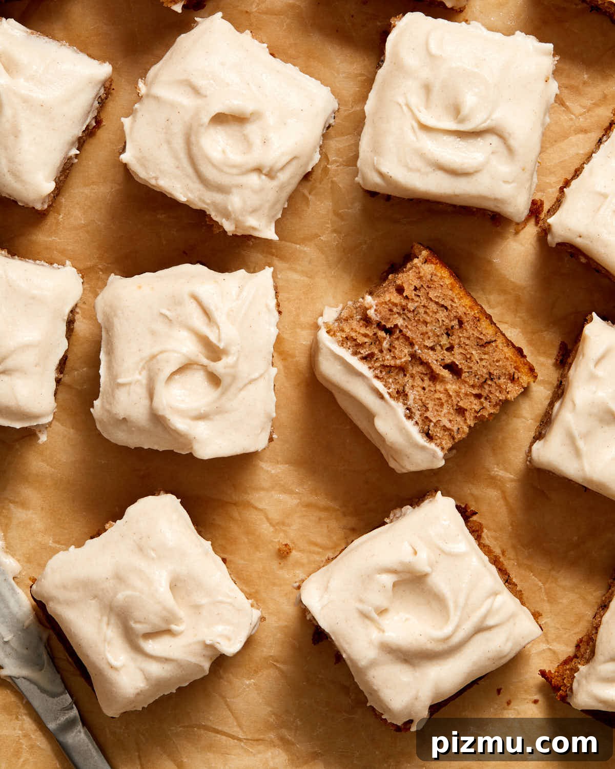 Moist Banana Cake Recipe with Vegetable Oil 3 Overhead view of pieces of banana cake arranged on brown parchment paper.