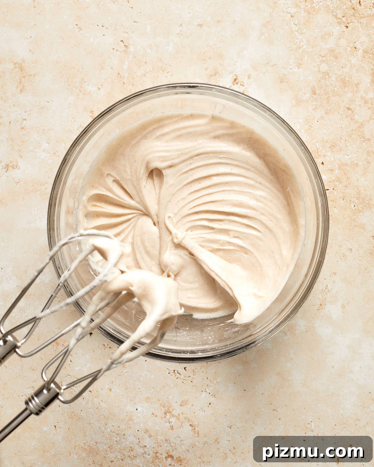 Moist Banana Cake Recipe with Vegetable Oil 6 Cinnamon cream cheese frosting in a glass bowl.