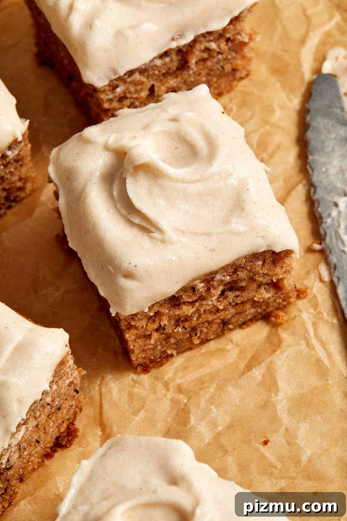 Moist Banana Cake Recipe with Vegetable Oil 7 Angled view of cinnamon cream cheese frosting swirled on top of a piece of cake.