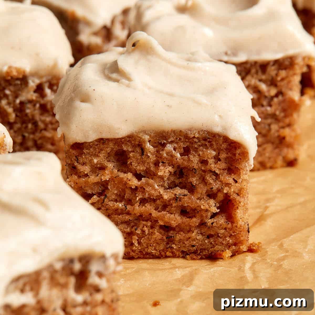 Moist Banana Cake Recipe with Vegetable Oil 9 Close up view of a piece of banana cake topped with cinnamon cream cheese frosting.