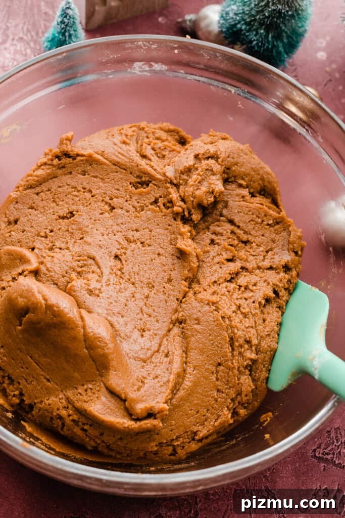 A bowl of molasses cookie dough.