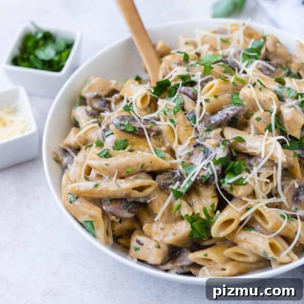 One-Pan Chicken Piccata Pasta with Lemon and Capers 17 Chicken marsala pasta with a wooden spoon.