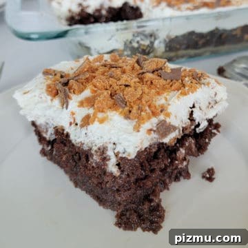 Butterfinger Cake Recipe with Chocolate Peanut Butter Crunch 11 Square of butterfinger poke cake next to a cake pan