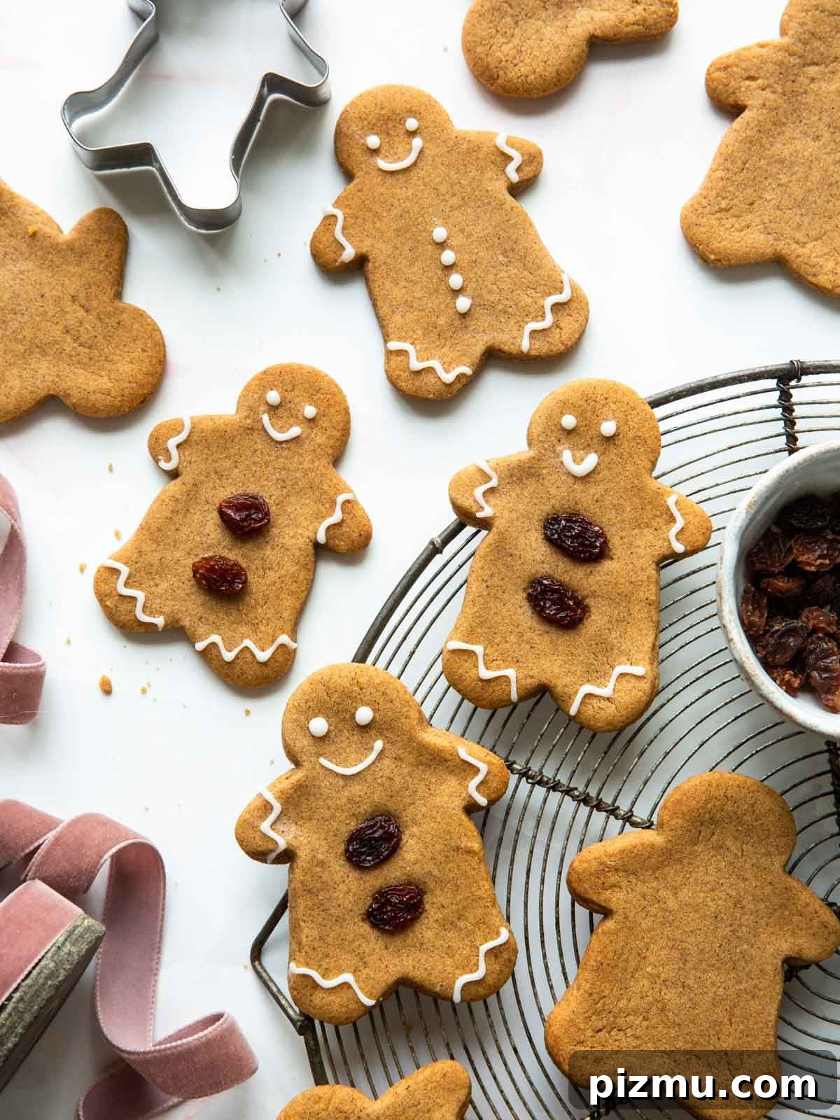 20 Classic Christmas Cookie Recipes to Bake This Season 3 gingerbread cookies on wire rack and table.