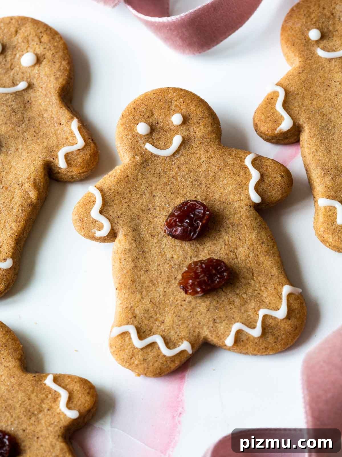 20 Classic Christmas Cookie Recipes to Bake This Season 14 gingerbread cookie with white icing and raisins.
