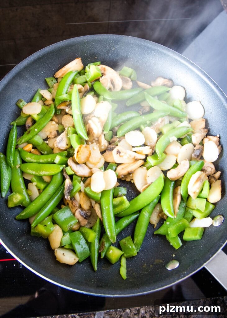 Garlic Sesame Stir-Fry Noodles with Veggies 5 veggies cooking in a skillet