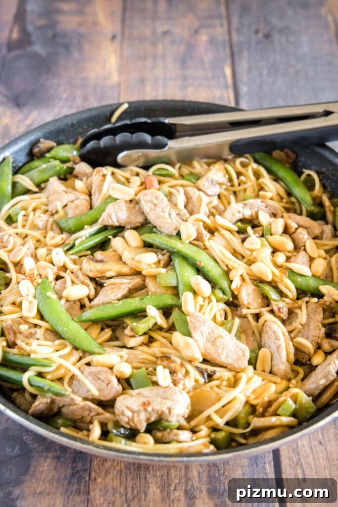 Garlic Sesame Stir-Fry Noodles with Veggies 7 looking down at asian noodle stir fryer in a large skillet