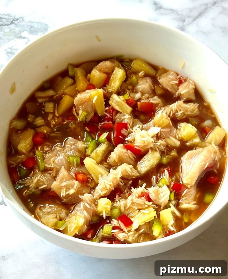 Pineapple Chicken and Rice Casserole Recipe 5 All the ingredients combined in a bowl for pineapple chicken and Rice casserole.