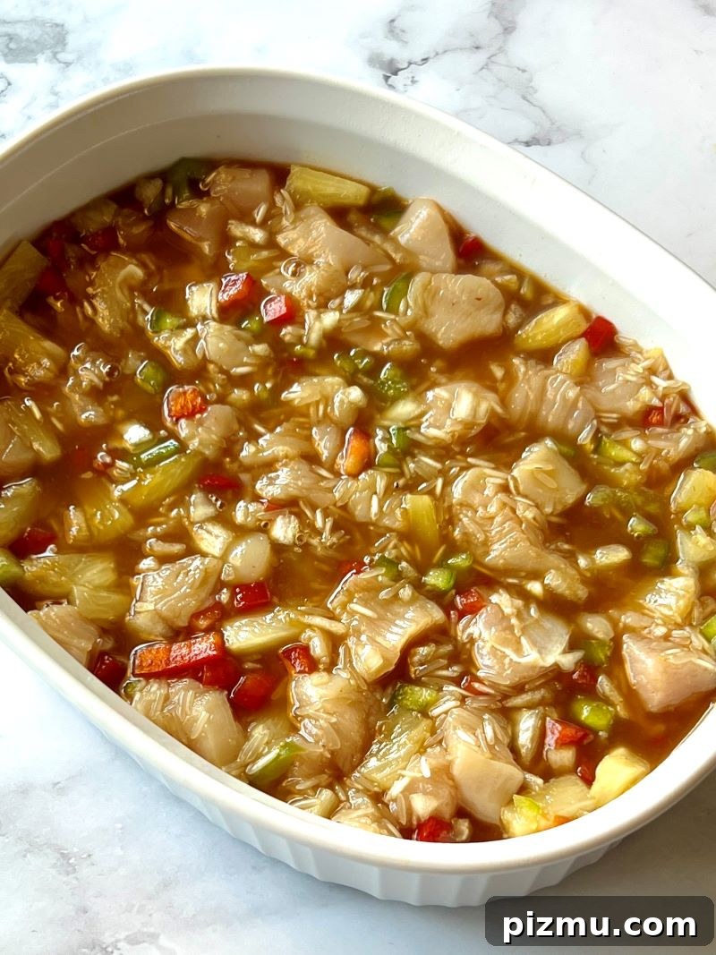 Pineapple Chicken and Rice Casserole Recipe 6 Pineapple chicken ingredients added to a baking dish.