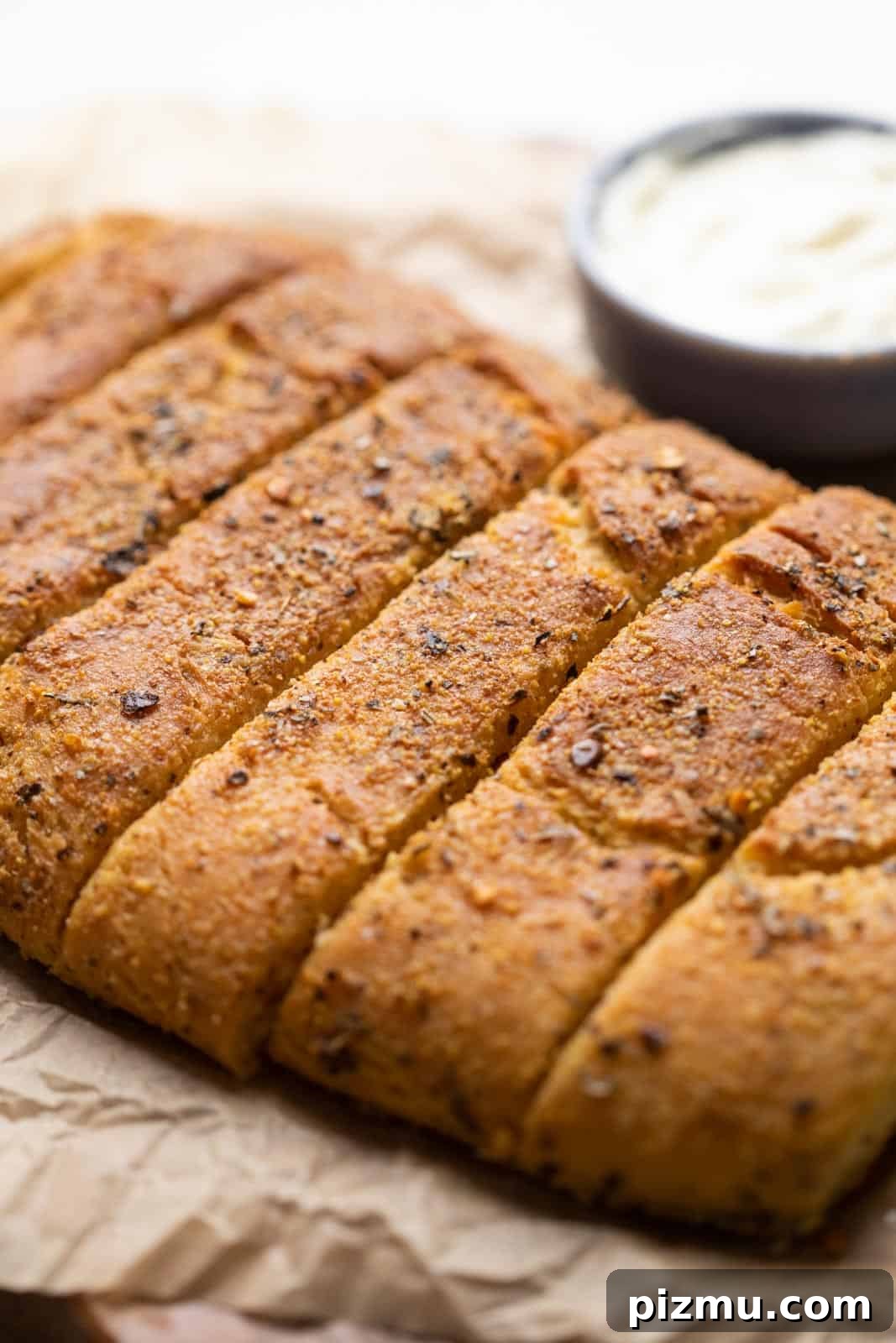 Domino-Style Garlic Breadsticks: Two Ways 3 Dominos garlic breadsticks placed on parchment paper to show the crunchy crust