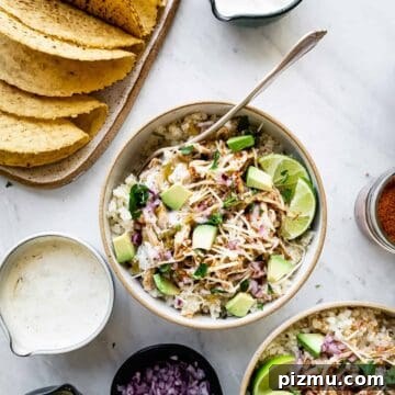 chicken taco bowls with ingredients in bowls around them