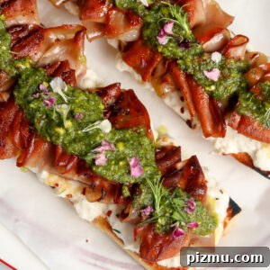 Mortadella Tartine with a homemade Stracciatella & Pistachio sauce on a plate.
