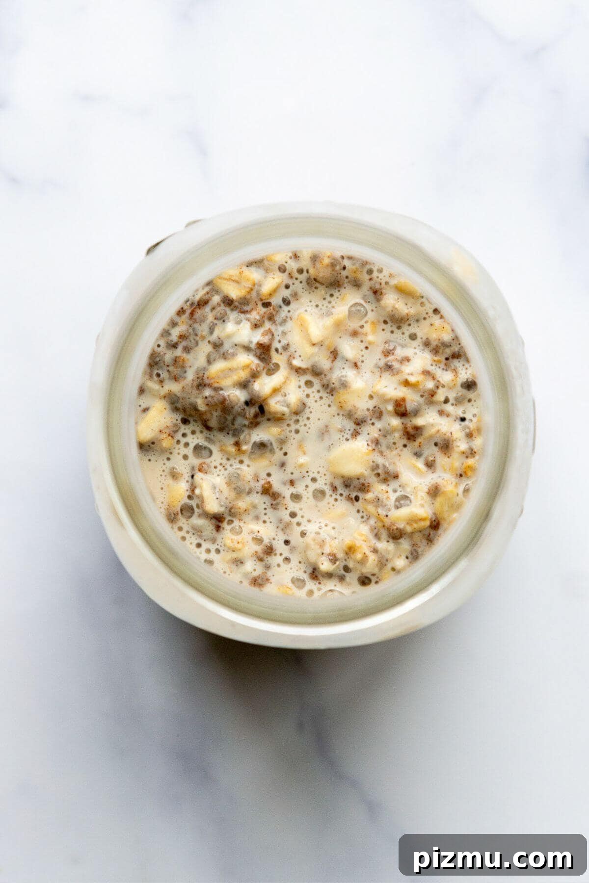 Creamy Cinnamon Overnight Oats for Make-Ahead Breakfast 5 Cinnamon overnight oats stirred together in a glass jar before chilling.