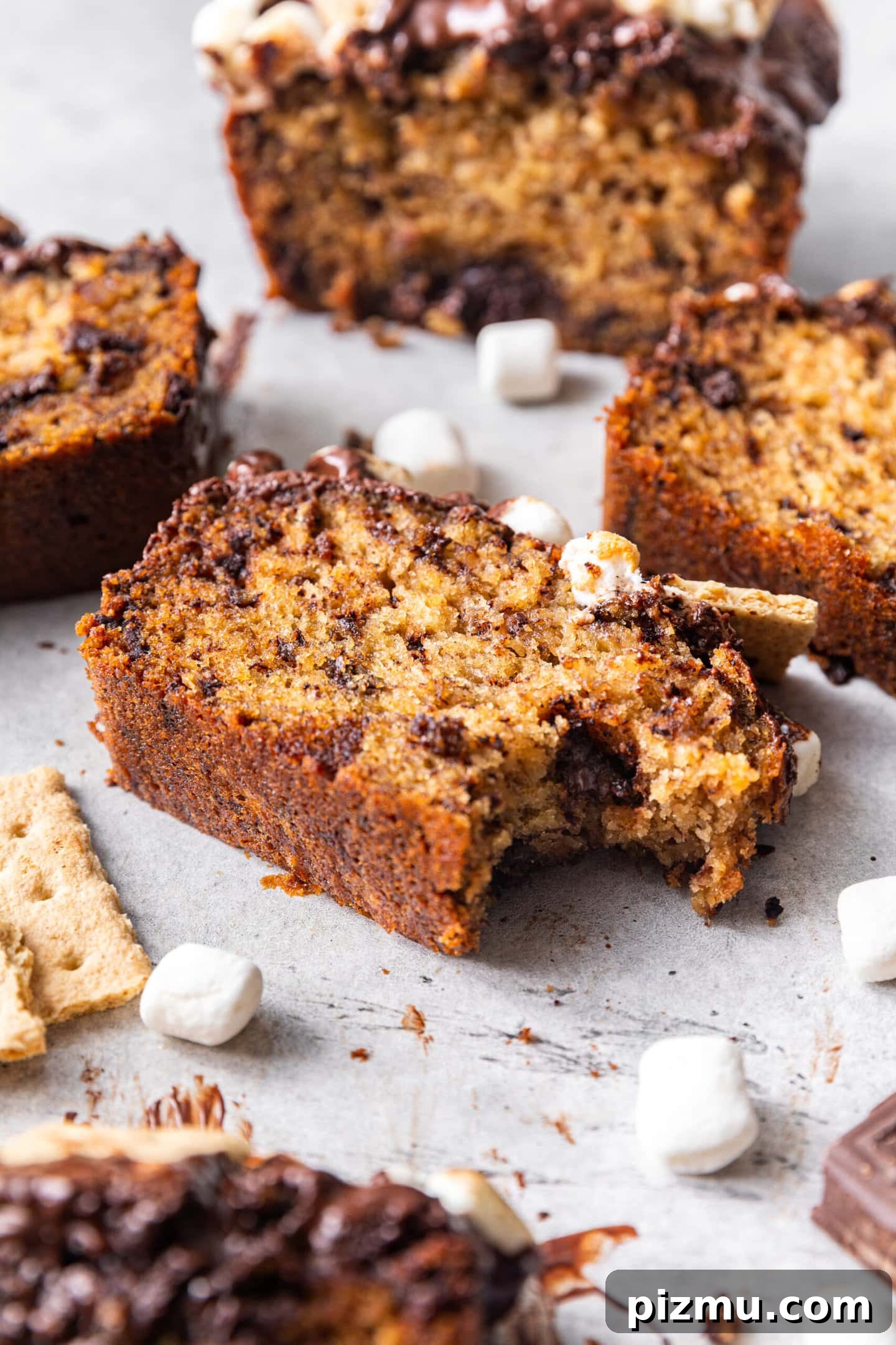 A slice of S'mores Banana Bread with a bite taken out of it