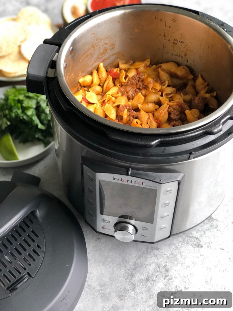 Instant Pot Cheesy Taco Pasta served with lime and tortilla chips