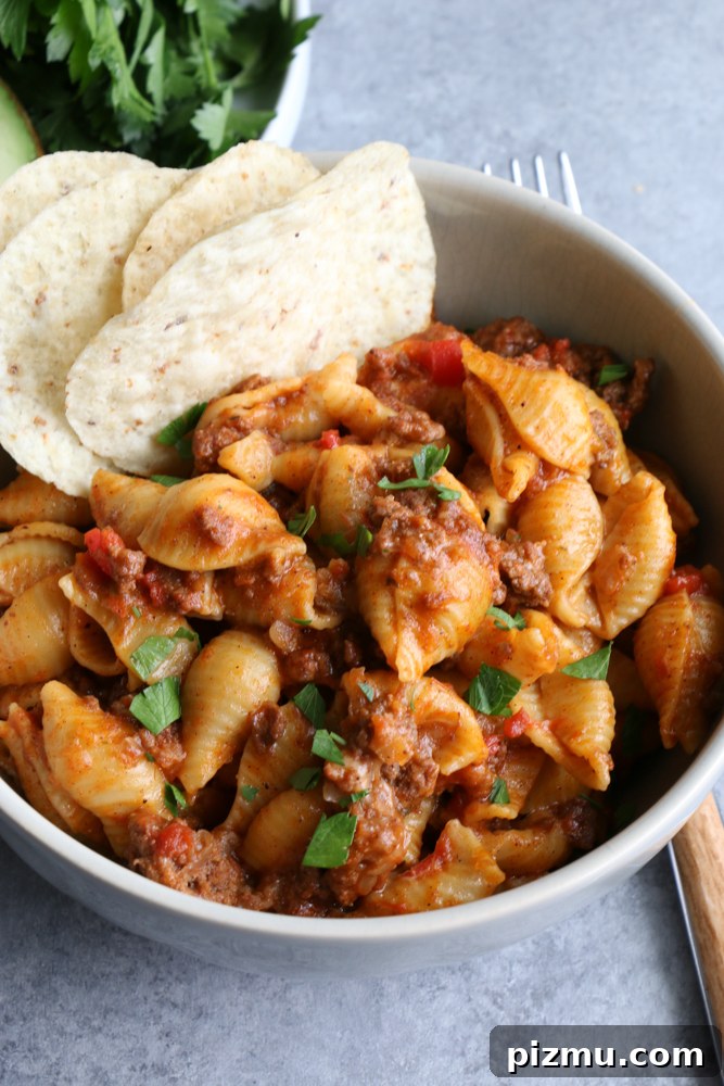 Finished Instant Pot Cheesy Taco Pasta plated with garnish