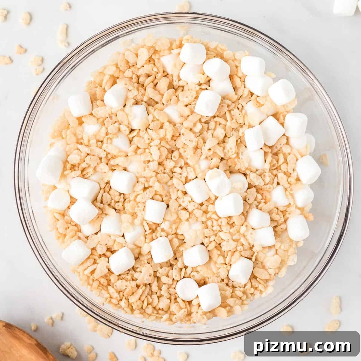 mini marshmallows and rice krispies mixed together in a bowl