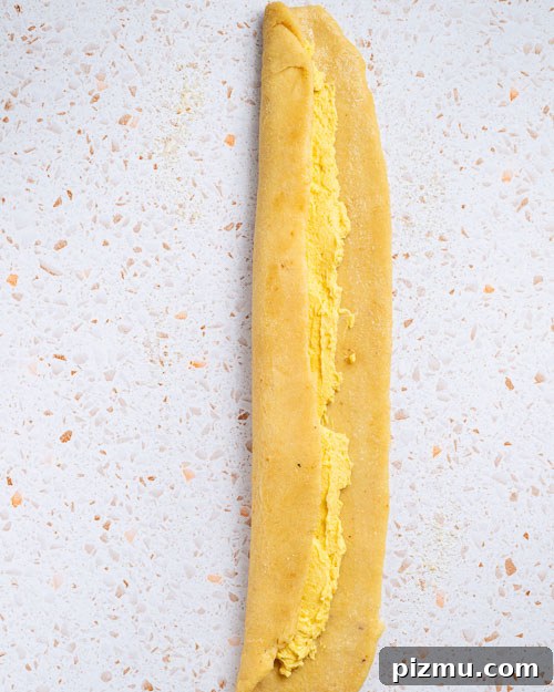 Keto Pumpkin Kringle Danish: Flaky Low-Carb Recipe 11 Rolling the dough over the filling.