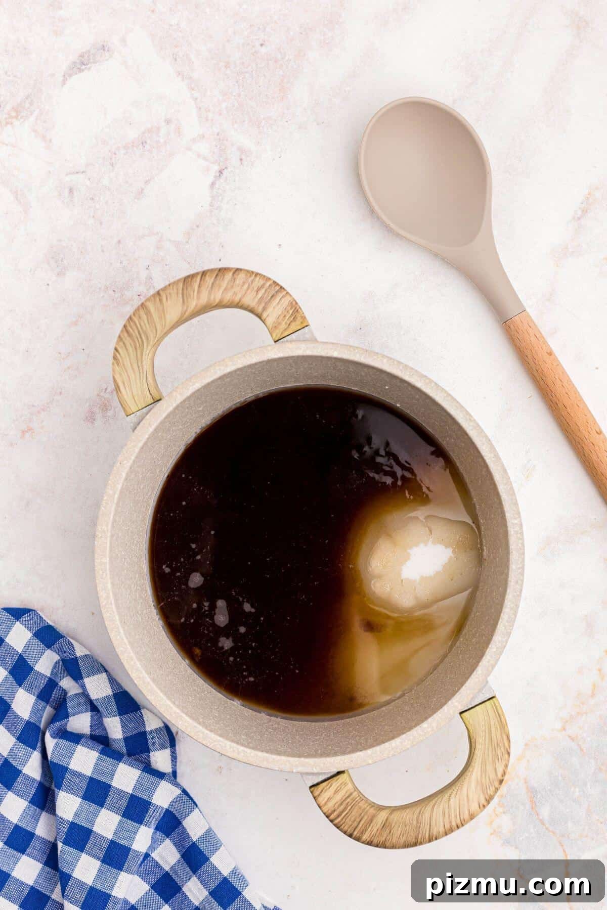 Sugars and water in a medium saucepan before being heated on a stove.
