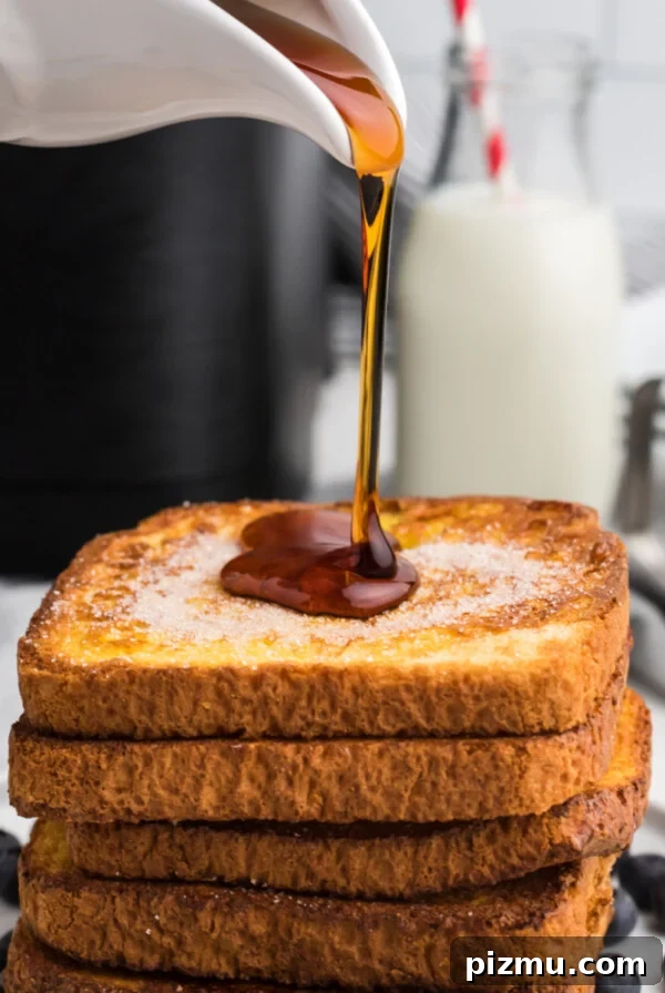 Syrup being poured on a stack of Air Fryer French Toast.
