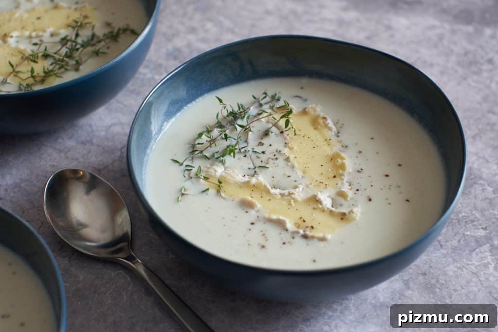 Creamy French Cauliflower Soup with Brie 8 Bowl of creamy cauliflower soup topped with brie.