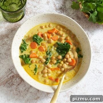 A bowl of chickpea stew with a gold spoon