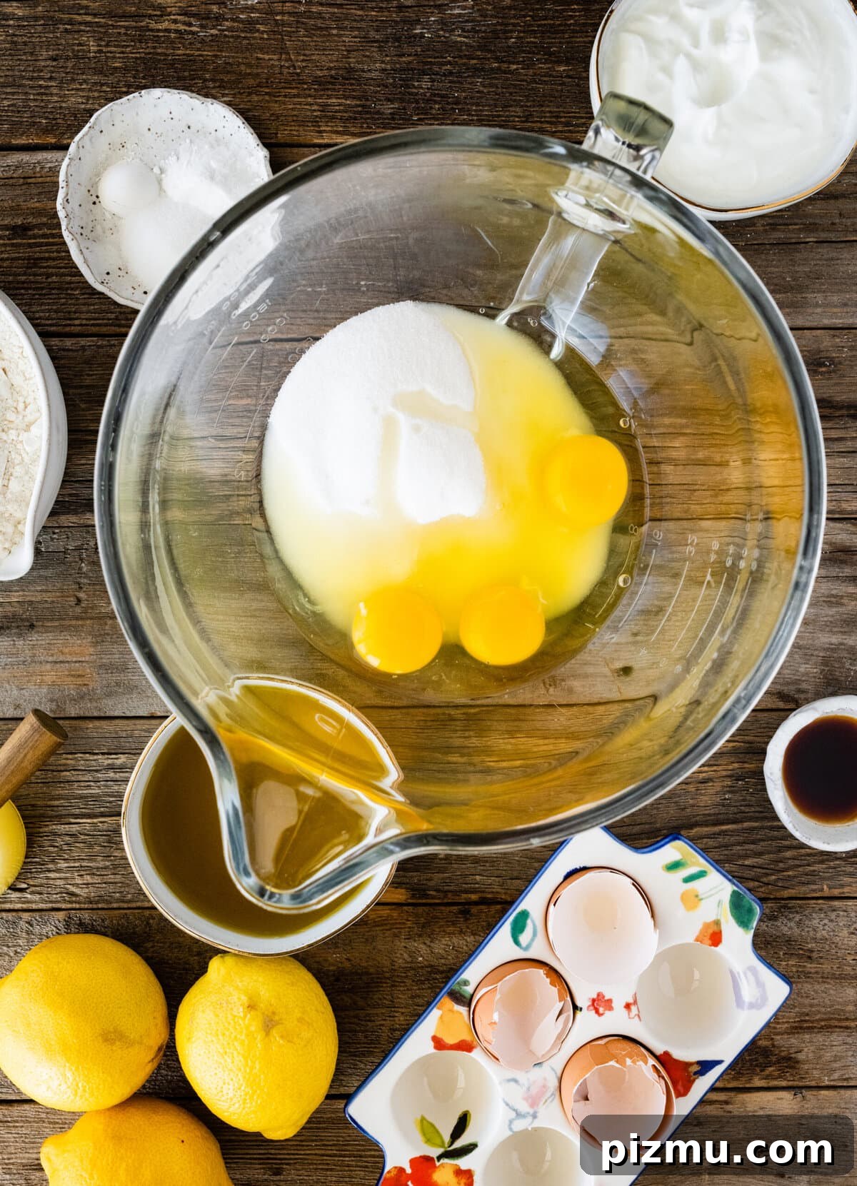 How to make olive oil cake (step-by-step) instructions- adding eggs and sugar to bowl.
