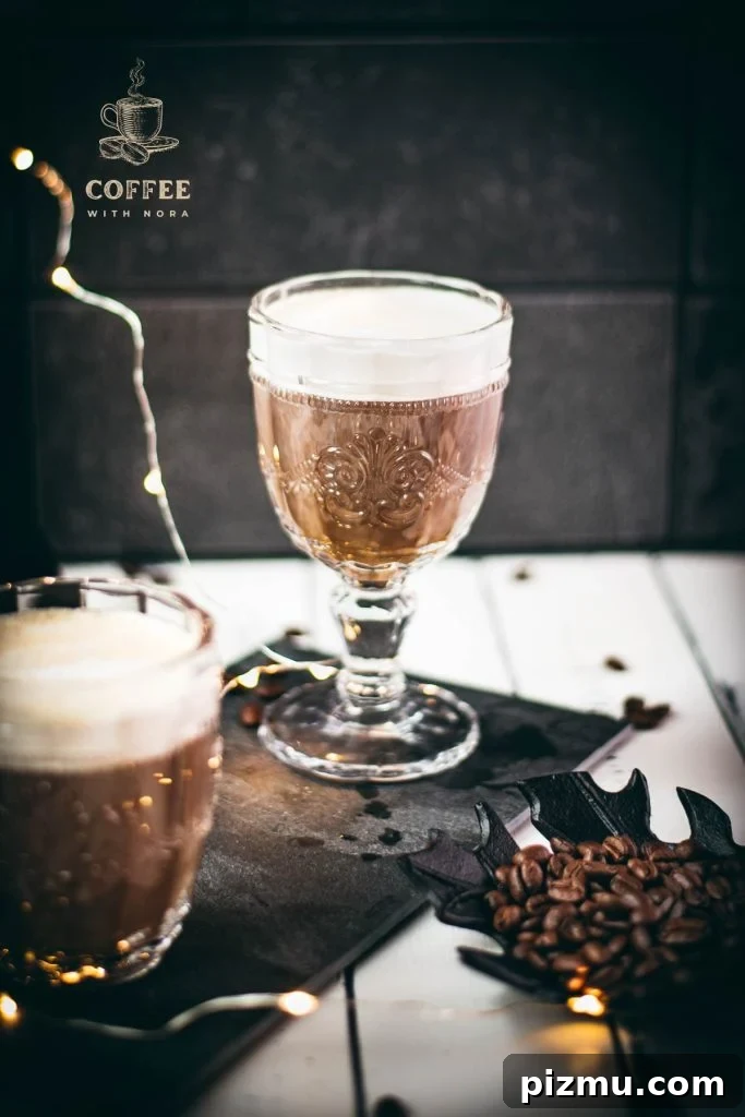 How to Make Café con Leche: Classic Spanish Coffee Recipe 5 Gorgeous glass filled with coffee con leche on dark slate plate.