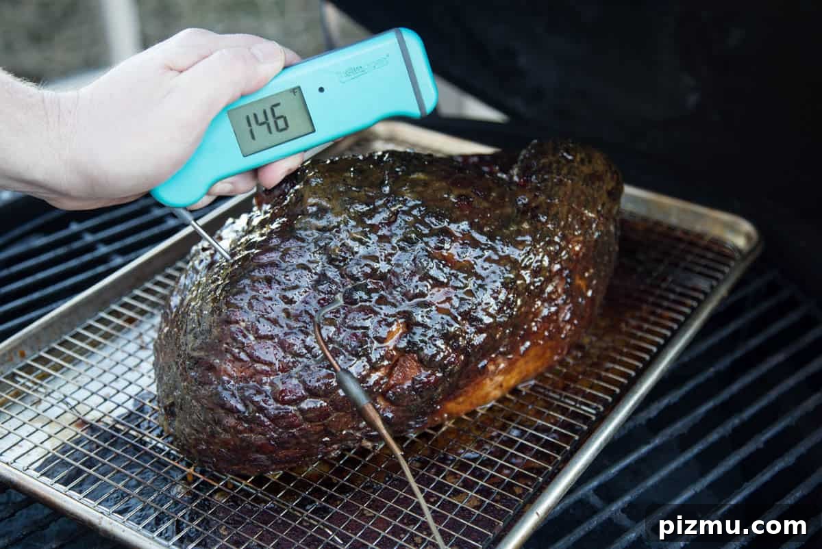 A Thermoworks Thermapen reading the temp of a smoked ham on a Big Green Egg.