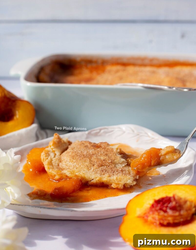 Classic Old-Fashioned Peach Cobbler Recipe 10 Side view of picking up a forkful of peach cobbler.