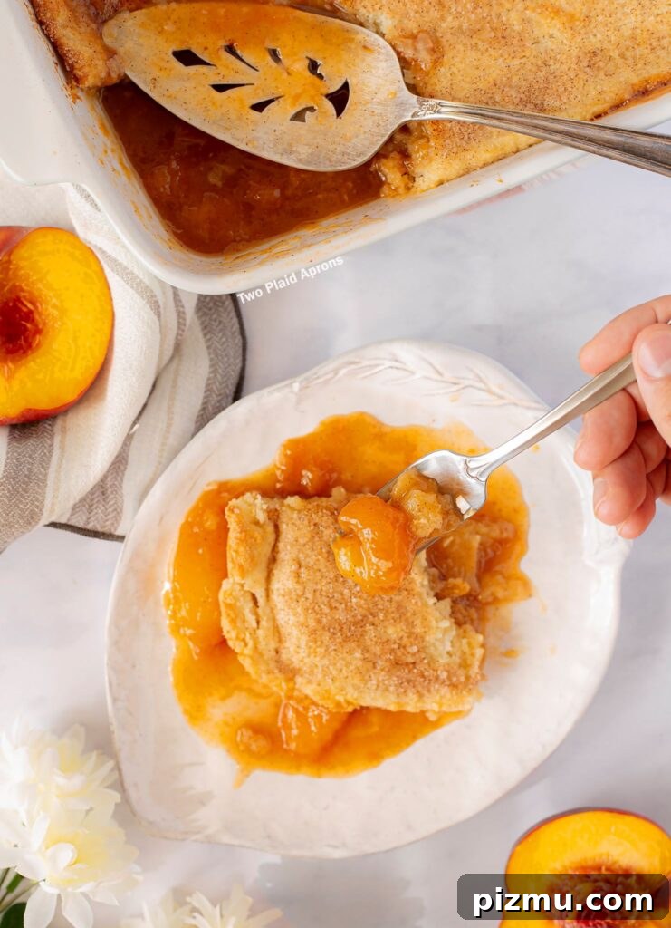 Classic Old-Fashioned Peach Cobbler Recipe 11 Top view of a forkful of old fashion peach cobbler.