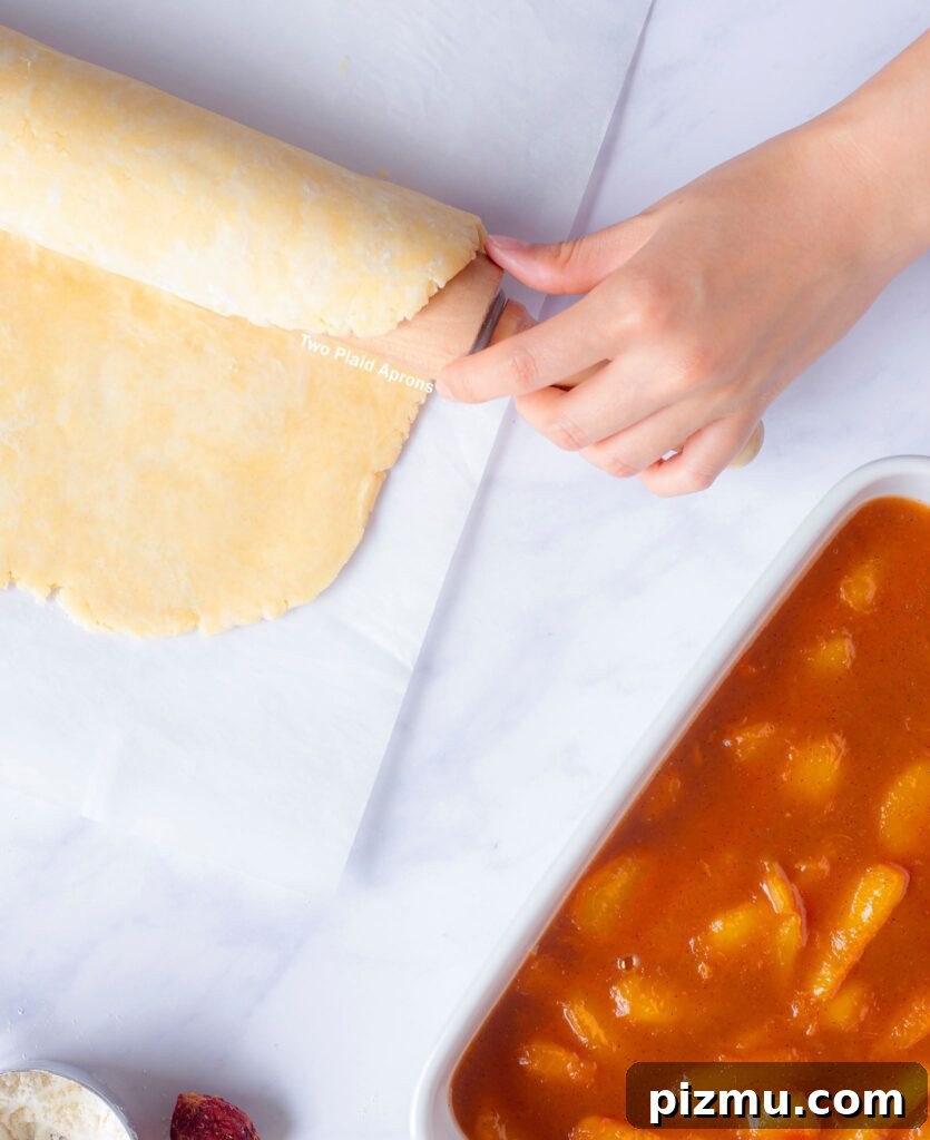 Classic Old-Fashioned Peach Cobbler Recipe 5 Rolling the crust dough onto a rolling pin for transferring.