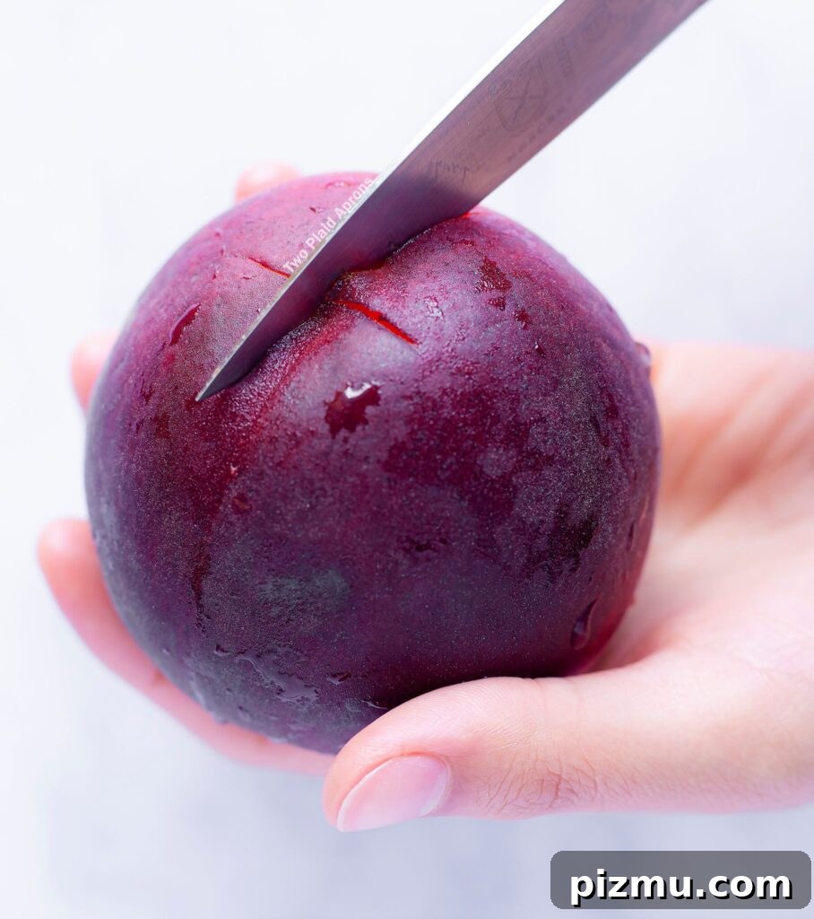 Classic Old-Fashioned Peach Cobbler Recipe 6 Making an "x" incision on the pointy end of a peach.